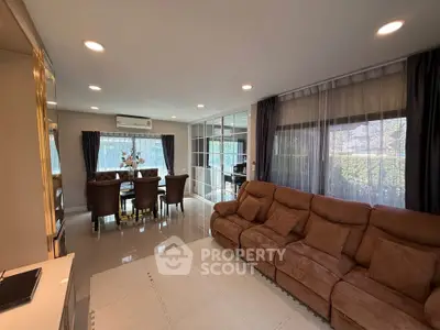Spacious living room with elegant dining area and large windows for natural light.