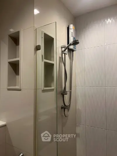 Modern bathroom with sleek shower design and built-in shelving