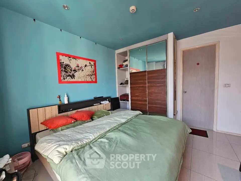 Spacious bedroom with modern decor and ample storage in a stylish home.