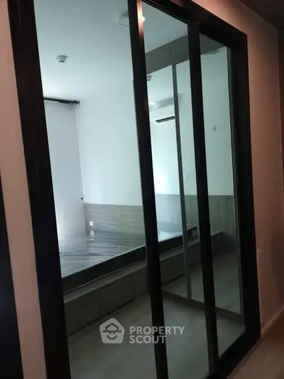 Modern bedroom with mirrored sliding doors and sleek design