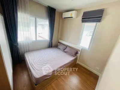 Cozy bedroom with natural light and modern air conditioning unit.