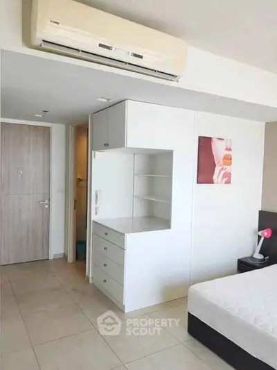 Modern bedroom with built-in storage and air conditioning unit