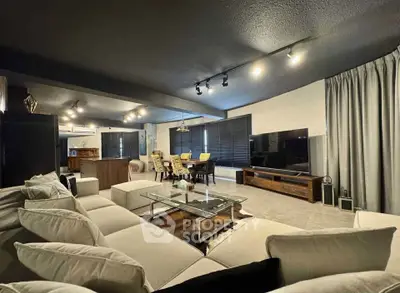 Spacious modern living room with elegant decor and large TV