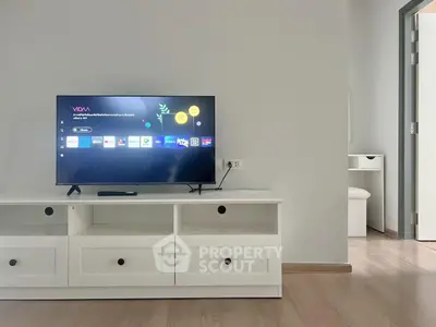 Modern living room with sleek TV setup and minimalist furniture design.