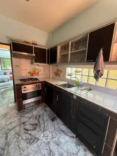 Charming kitchen with modern appliances and stylish cabinetry in a cozy home setting.