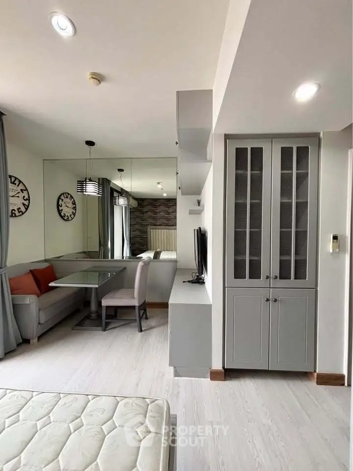 Modern living room with dining area and stylish decor in a cozy apartment.