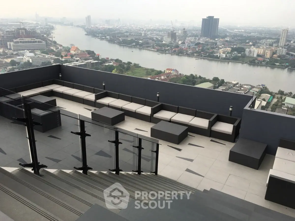 Stunning rooftop terrace with panoramic city and river views, perfect for relaxation and entertainment.