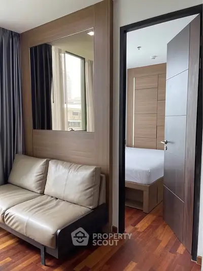 Modern apartment interior with cozy living room and glimpse of stylish bedroom
