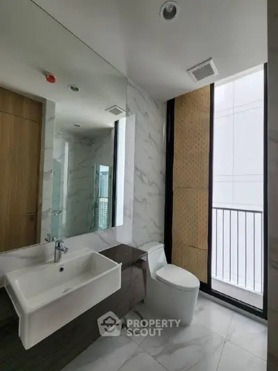 Modern bathroom with sleek fixtures and large window for natural light.