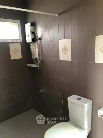 Modern bathroom with sleek tiles and shower setup