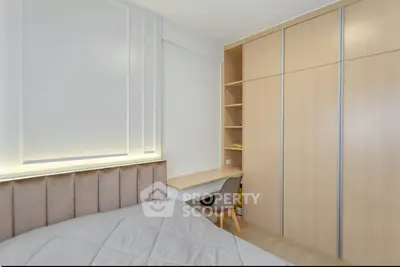 Modern bedroom with built-in wardrobe and cozy workspace
