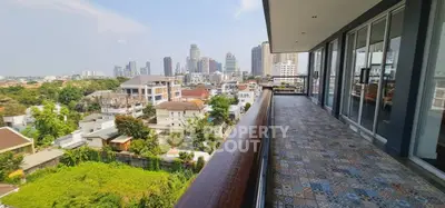 Spacious balcony with stunning city skyline view, perfect for relaxation and entertainment.