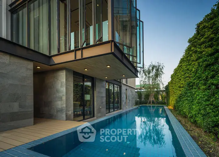 Luxurious modern home with private pool and lush garden view