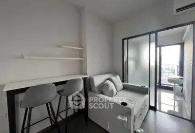 Modern compact living room with sleek furniture and balcony access