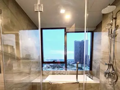 Luxurious bathroom with city view and modern shower fixtures.