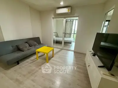 Modern living room with sleek furniture and bright yellow table
