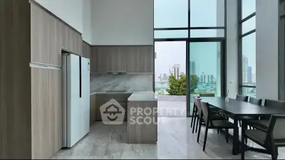 Modern kitchen with open layout and dining area featuring floor-to-ceiling windows and city view.
