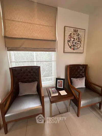 Stylish modern living room with elegant chairs and decor, perfect for relaxation and reading.