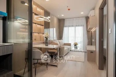 Modern living room with elegant decor and natural light, featuring a cozy seating area and stylish dining space.