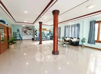 Spacious living room with elegant columns and ample natural light