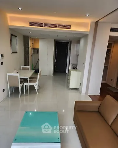 Modern living room with dining area and sleek furniture in a stylish apartment