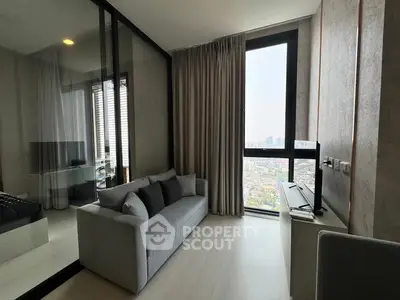 Modern living room with city view, featuring sleek design and floor-to-ceiling windows.
