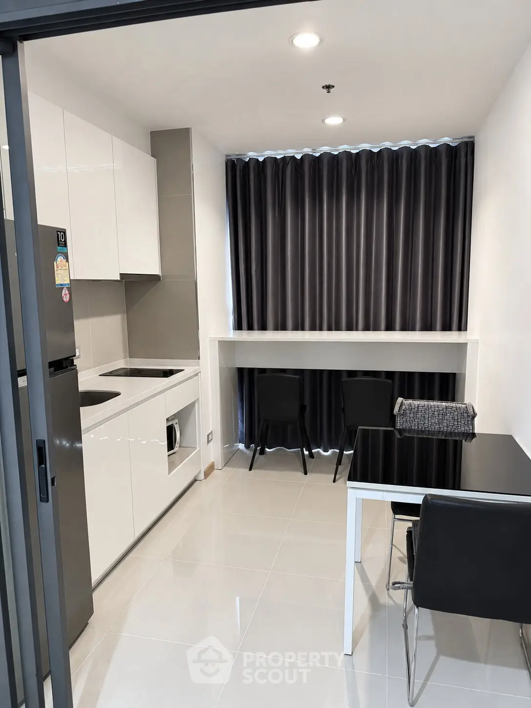 Modern kitchen with sleek design and dining area in a contemporary apartment