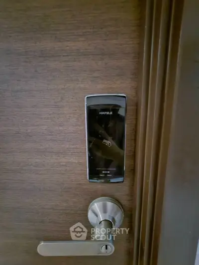 Modern digital door lock on wooden door for secure home entry