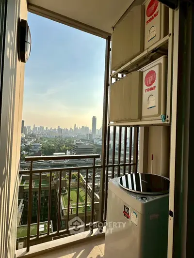 Stunning city view from a high-rise balcony with modern air conditioning units.