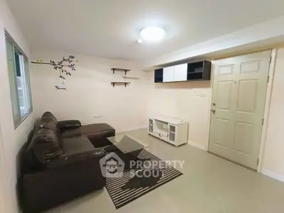 Cozy living room with modern decor and comfortable seating in a stylish apartment.