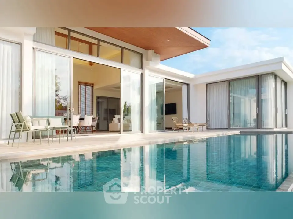 Luxurious modern villa with expansive pool and elegant outdoor seating area.