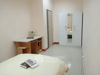 Cozy bedroom with modern wardrobe and study desk, perfect for comfortable living.