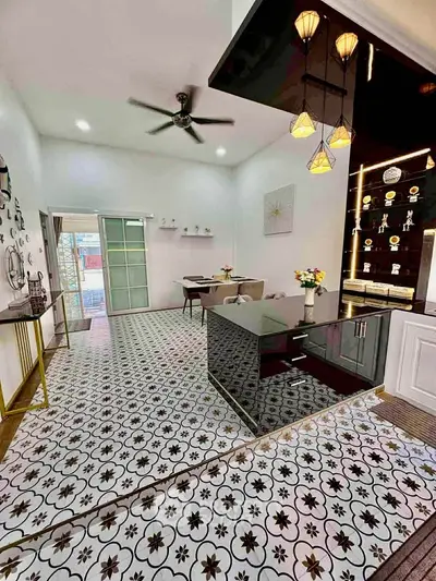 Stylish open-plan living room with modern decor and patterned tile flooring