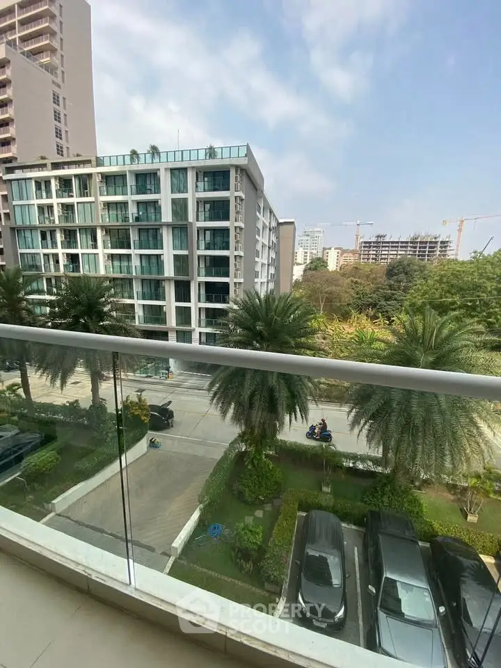 Modern apartment view with lush greenery and urban skyline