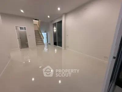 Spacious modern interior with glossy floors and staircase, ideal for customization.