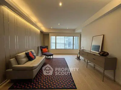 Spacious modern living room with stylish decor and large window for natural light.