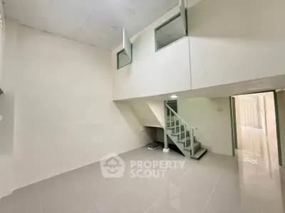 Spacious modern interior with mezzanine and sleek tiled flooring