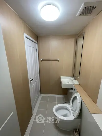 Modern minimalist bathroom with sleek fixtures and wood paneling