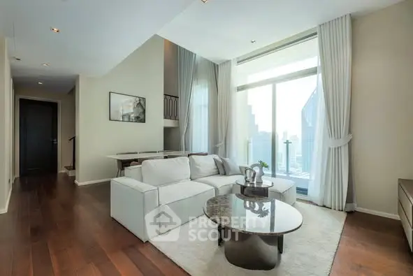 Luxurious modern living room with high ceilings and large windows offering stunning city views.