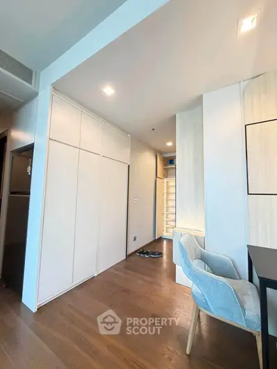 Modern apartment interior with sleek wooden flooring and stylish furniture, showcasing a cozy and functional living space.