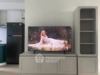 Modern living room with sleek TV setup and stylish shelving unit, perfect for contemporary living.