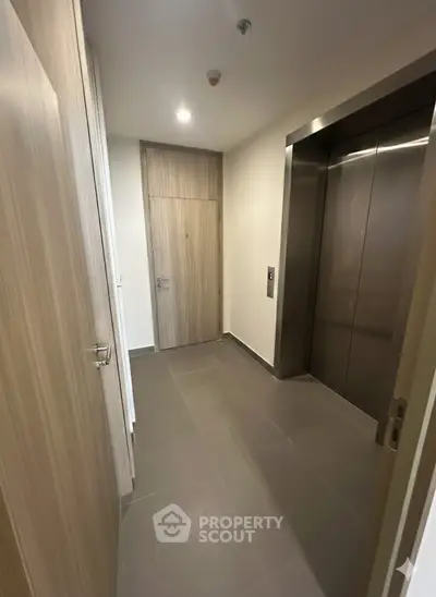 Modern apartment elevator lobby with sleek design and wooden accents