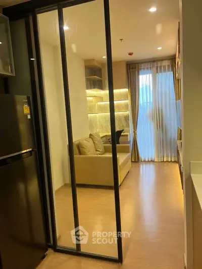 Modern apartment interior with sliding glass door and cozy living area