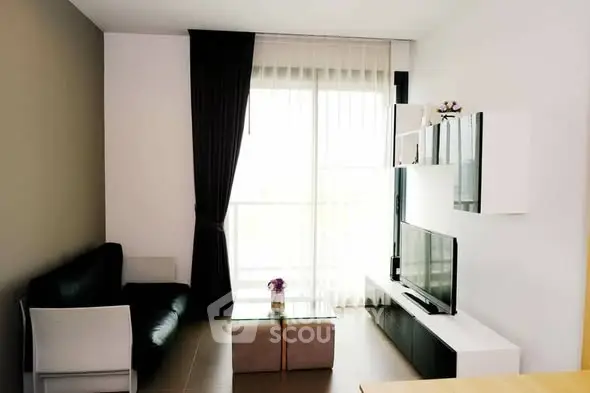 Modern living room with sleek furniture and large window for natural light.