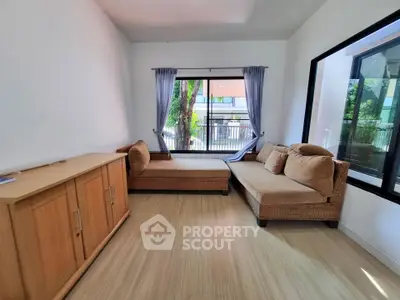 Cozy living room with natural light and stylish furniture, perfect for relaxation and entertaining guests.