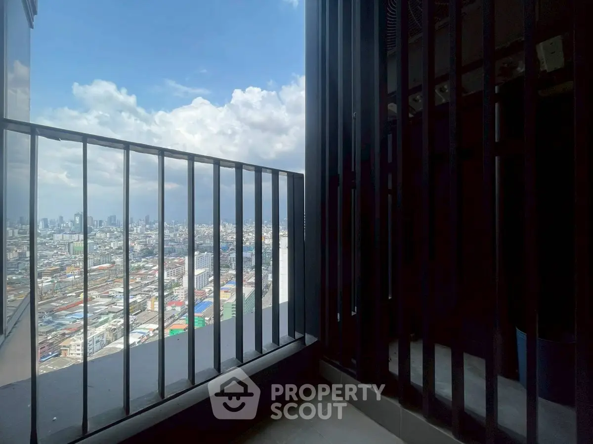 Stunning cityscape view from a high-rise balcony with modern railing design.