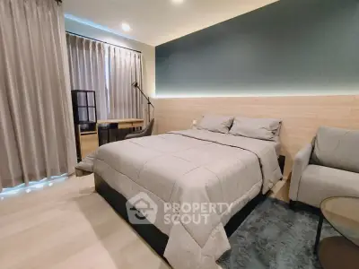 Modern bedroom with cozy bed, stylish lighting, and elegant decor