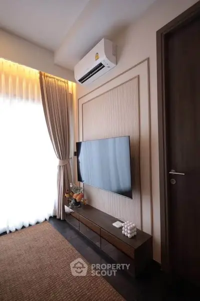 Modern living room with wall-mounted TV and elegant decor