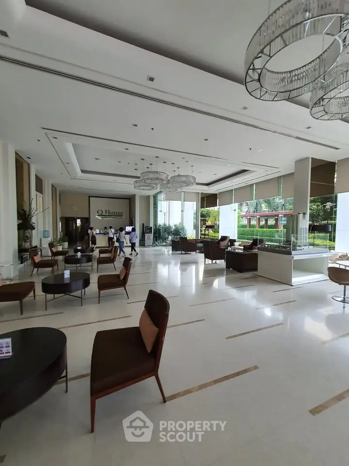 Luxurious modern lobby with elegant seating and large windows overlooking greenery