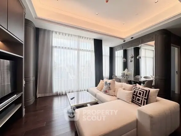 Luxurious living room with elegant decor and large windows offering natural light.